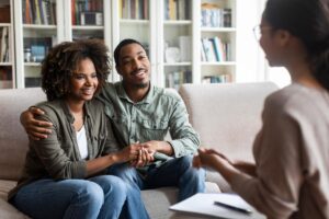 husband and wife talk with therapist in a family therapy program